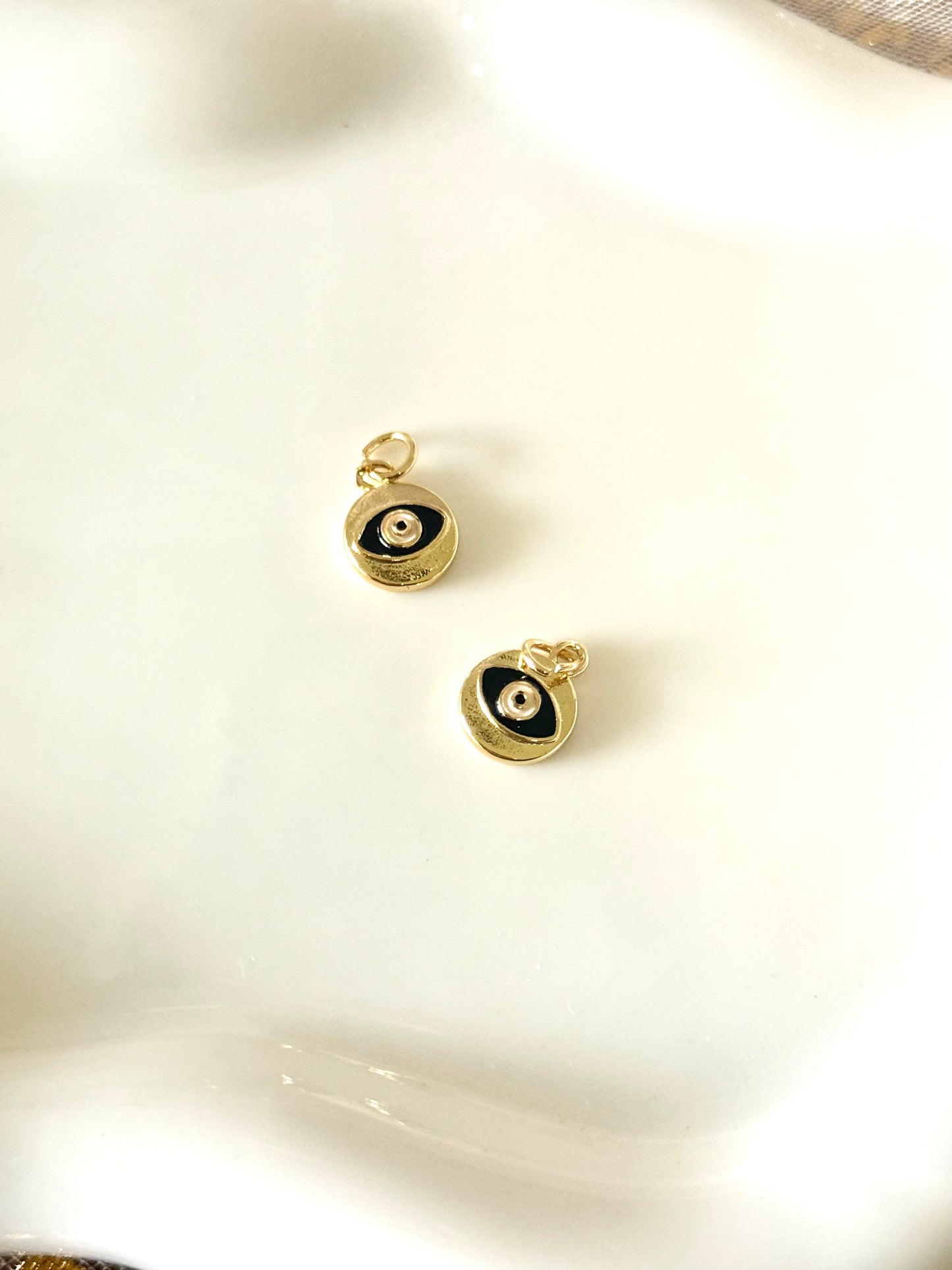 Mini round black eye charm